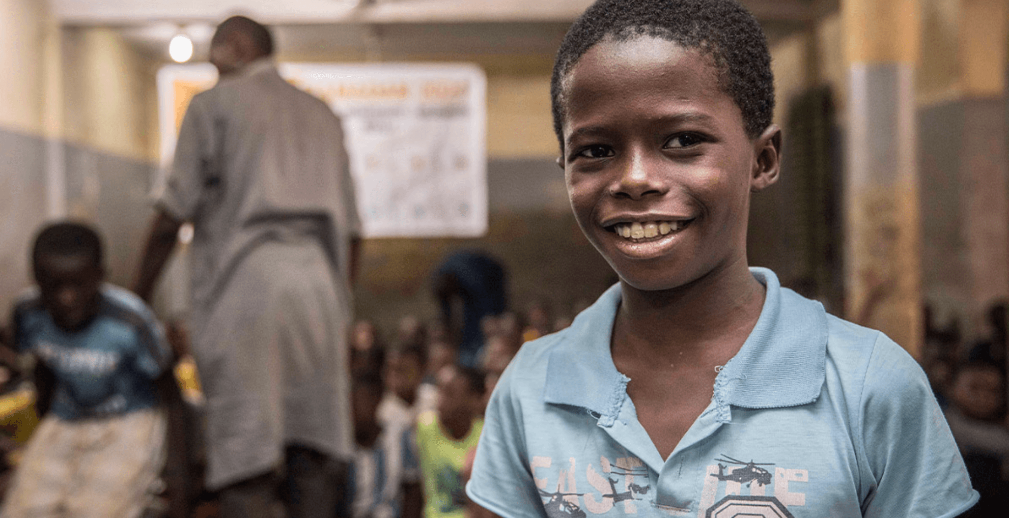 Un jeune talibé souriant dans sa salle de classe